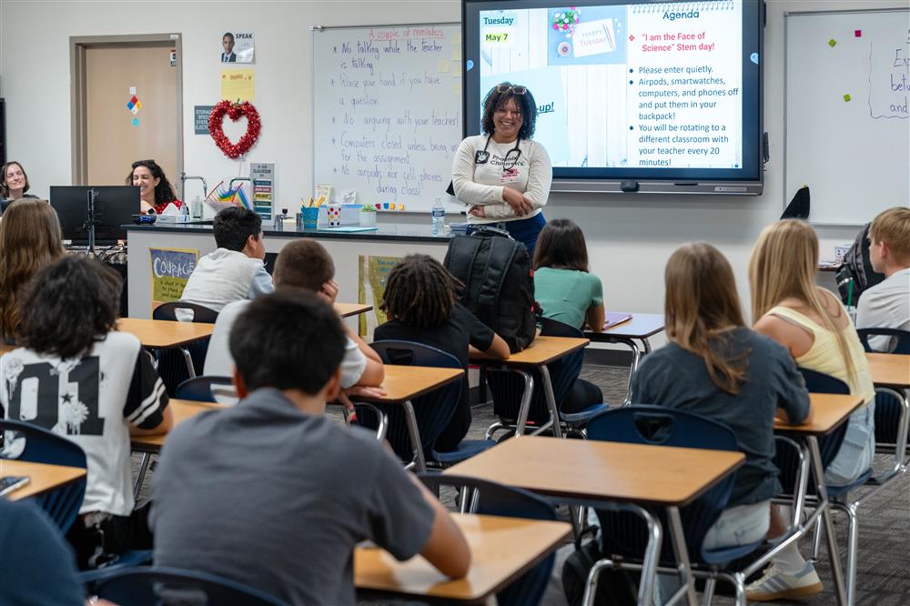 A guest speaker talks with a class.